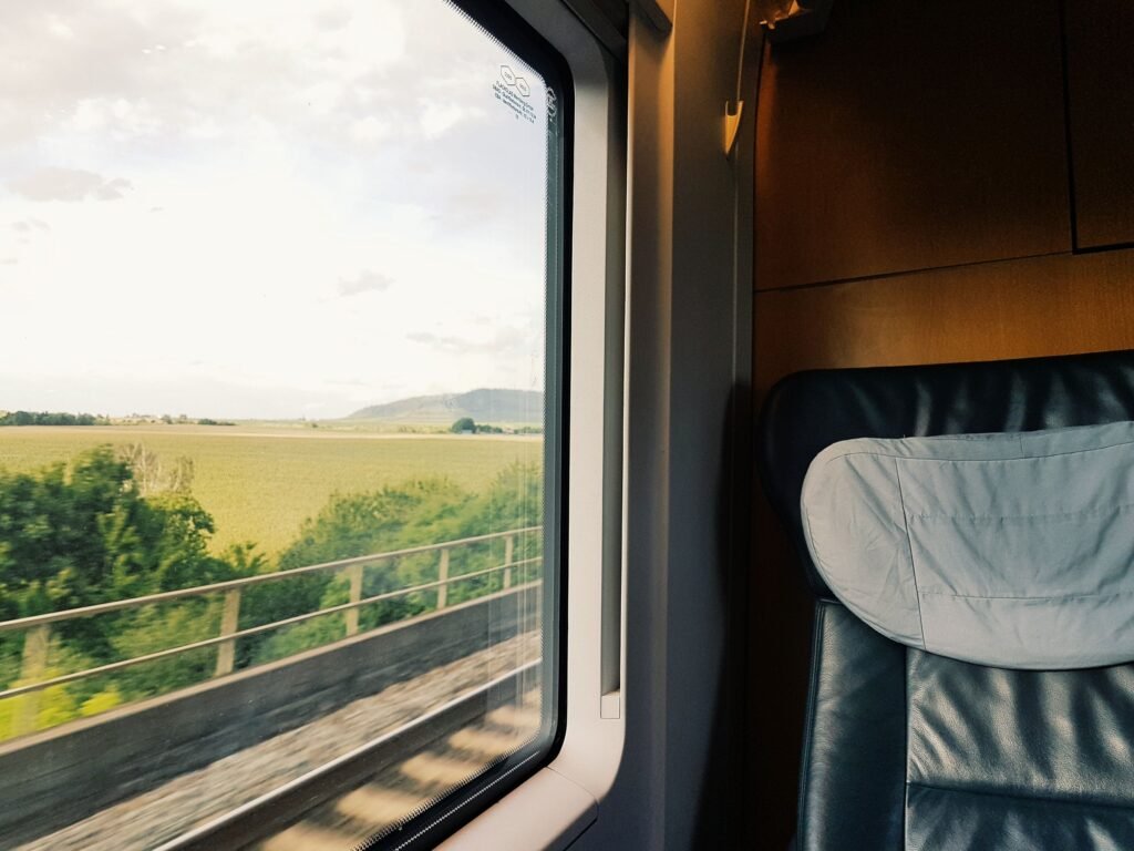 A view of green countryside through a train window