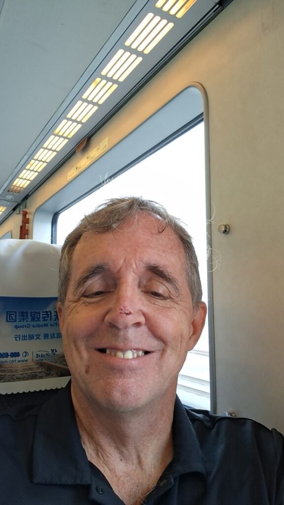 Doug riding a train in Japan