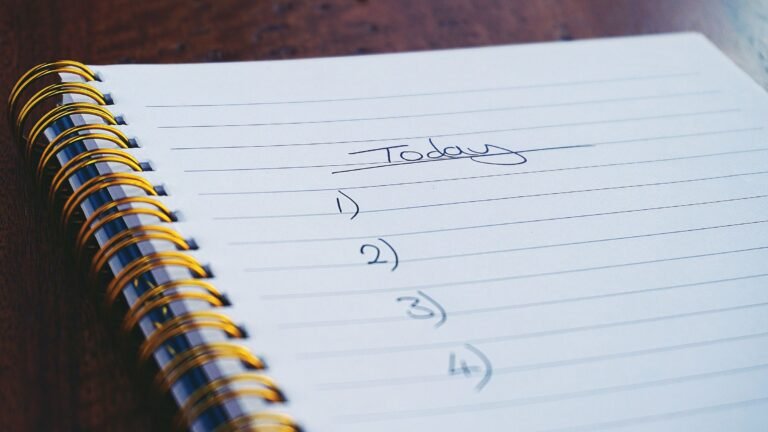 A spiral notebook open to a handwritten numbered to-do list